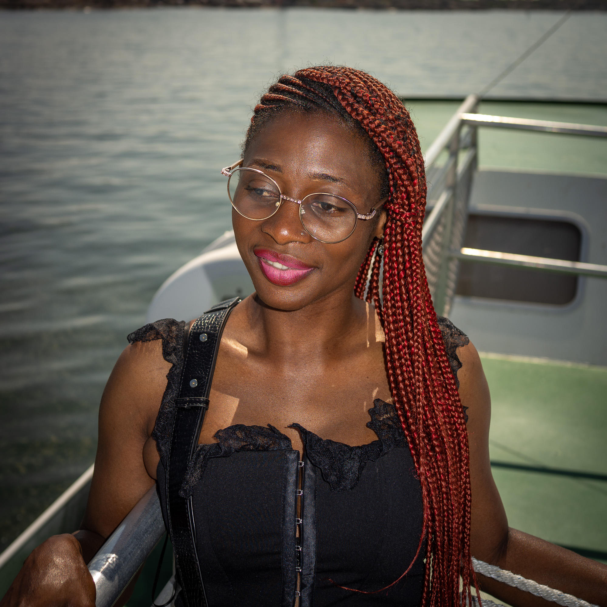 Jamirah smiling on a boat by the Swedish archipelago in bright summer light
